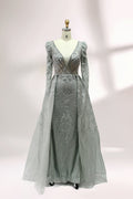 Illuminated softly, a mannequin showcases a light - gray evening gown. With a deep V - neckline, long puffed sleeves, and elaborate bead and lace embroidery, the gown exudes an air of luxury and sophistication, making it an excellent choice for formal galas and upscale events.1