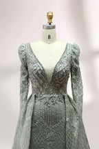 Illuminated softly, a mannequin showcases a light - gray evening gown. With a deep V - neckline, long puffed sleeves, and elaborate bead and lace embroidery, the gown exudes an air of luxury and sophistication, making it an excellent choice for formal galas and upscale events.7