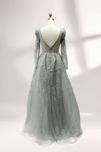 Illuminated softly, a mannequin showcases a light - gray evening gown. With a deep V - neckline, long puffed sleeves, and elaborate bead and lace embroidery, the gown exudes an air of luxury and sophistication, making it an excellent choice for formal galas and upscale events.2