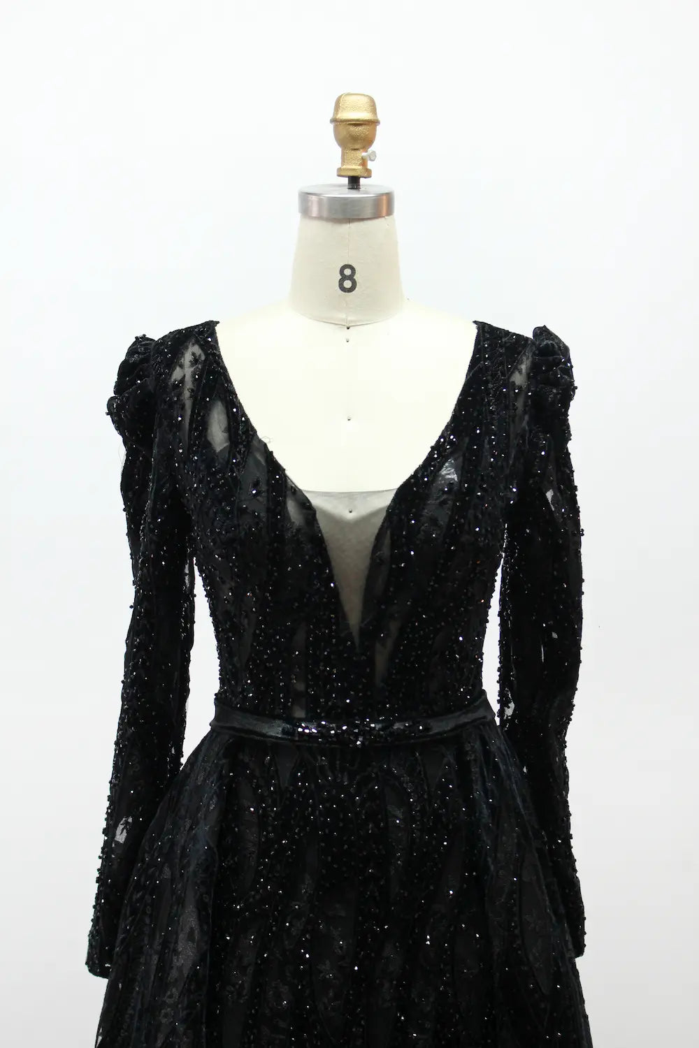 Black long-sleeve sequin evening dress with V-neck bodice and puffed shoulders