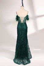 A mannequin displays a dark green strapless evening gown. It has feather - trimmed cups and a sequined, form - fitting skirt that reaches the floor, with a side slit. The intricate design and shimmering texture make it elegant for formal events.02