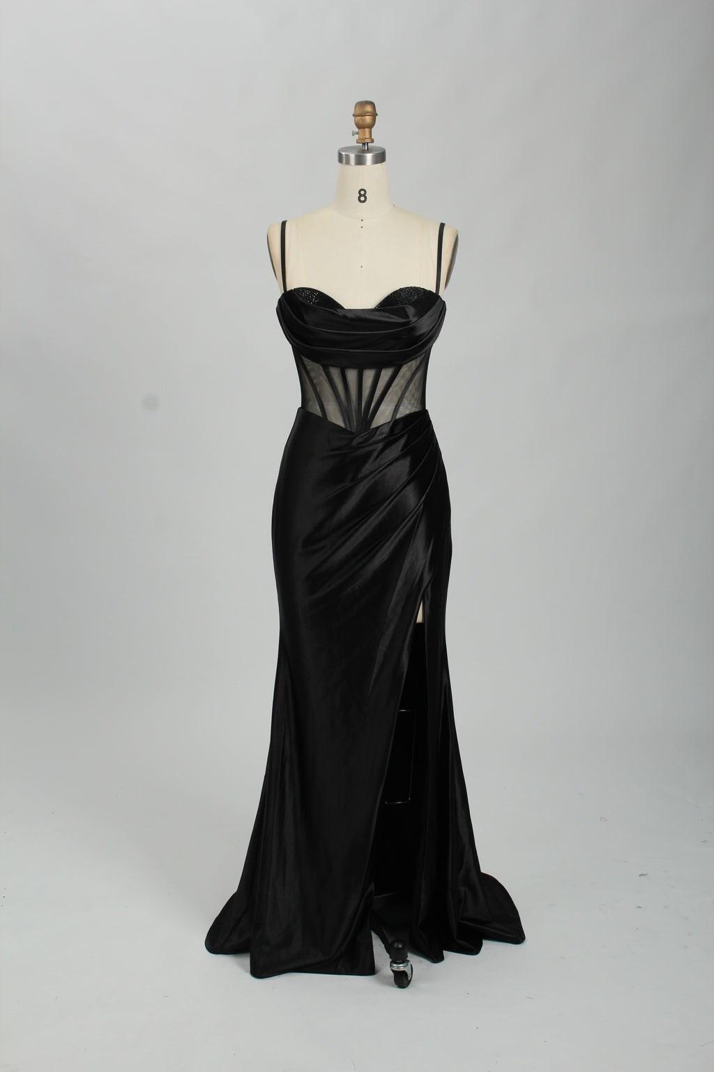 Black satin prom dress with sheer corset bodice, side slit & drape. Luxe, eye-catching design—perfect for bulk orders in premium formal collections.