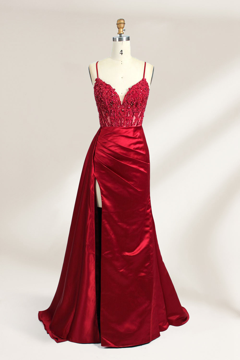 A mannequin showcases a royal - blue gown with thin straps. The bodice features intricate bead embroidery and sheer panels, while the skirt has a ruched design and a high side slit. The satin fabric and elegant details make it perfect for formal events like proms or galas, exuding sophistication.5