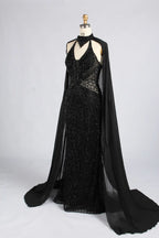 Black beaded mermaid gown with halter neckline and flowing cape train