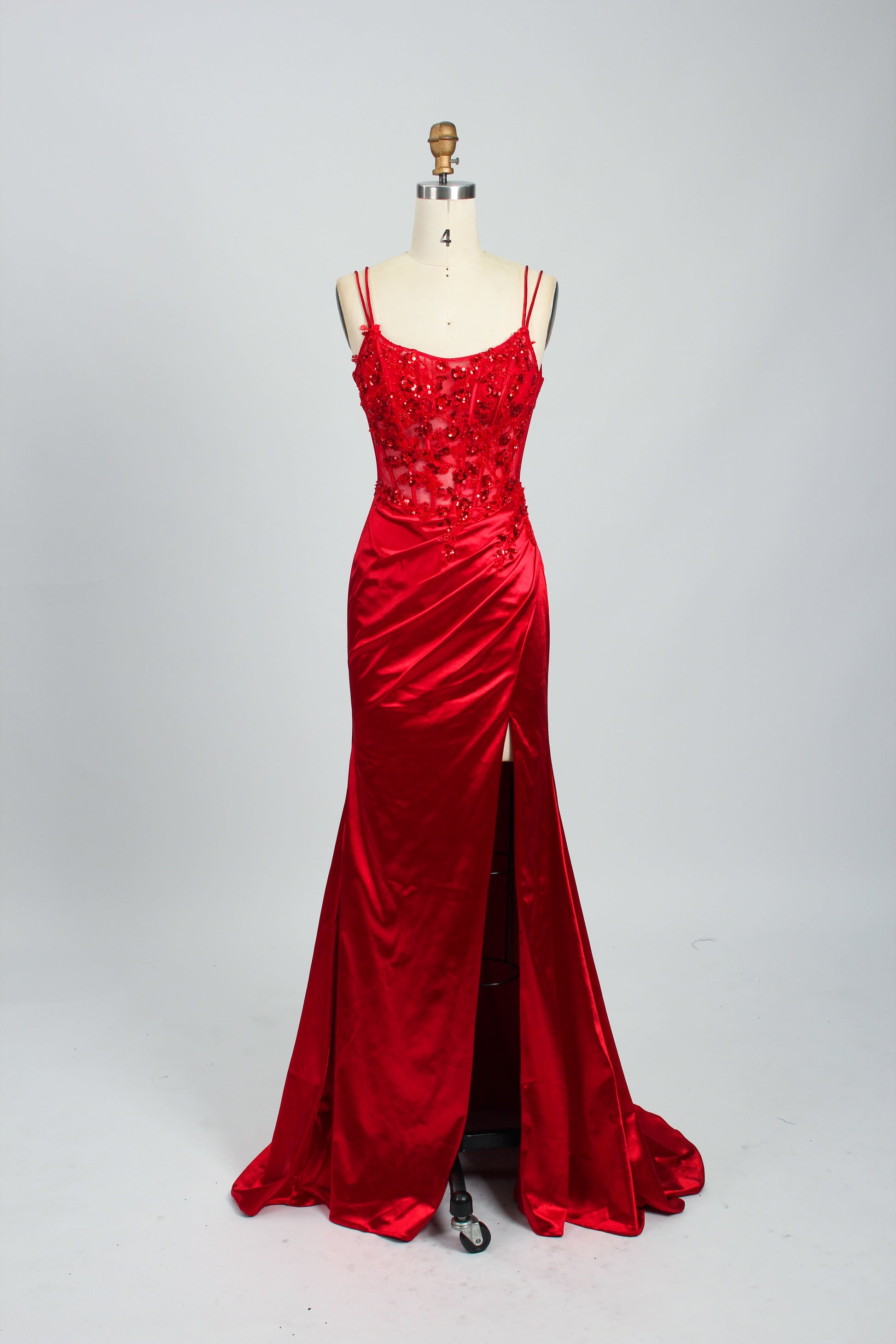 This is a floor - length evening dress in a deep navy hue. It has a strapless style with thin shoulder straps. The bodice is embellished with delicate beadwork and embroidery, creating an elegant and glamorous look. The skirt is form - fitting around the hips and flows down to the floor, featuring a side slit that adds allure and allows for easy movement. Displayed on a mannequin against a simple, light - colored backdrop, the dress exudes sophistication, perfect for special occasions like galas or proms.08