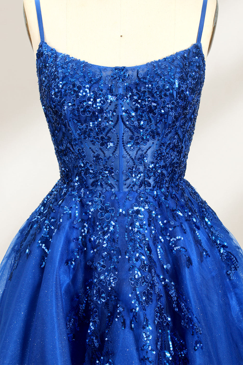 A mannequin displays a royal - blue, short - length gown with thin straps. The bodice and skirt are adorned with sparkling sequins and floral lace. The tulle skirt adds a fluttery, feminine touch, perfect for semi - formal events like homecoming or cocktail parties, exuding youthful charm.3