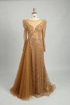 Gold long-sleeve mermaid gown with shimmering beaded lace and layered tulle underskirt