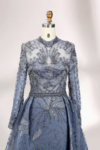 Presented on a mannequin is a blue - toned evening gown. It has a high neckline, long sheer sleeves, and intricate floral embroidery. The elegant design gives off a luxurious and sophisticated vibe, ideal for formal occasions.7
