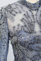 Presented on a mannequin is a blue - toned evening gown. It has a high neckline, long sheer sleeves, and intricate floral embroidery. The elegant design gives off a luxurious and sophisticated vibe, ideal for formal occasions.6
