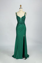 A woman with sleek dark hair and a poised stance wears a red, glittery gown. It has thin straps, beaded bodice, and a high side slit. Paired with silver heels, the outfit radiates elegance, perfect for formal events like galas, blending glamour and style.
7