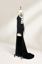 Displayed on a mannequin is a black evening gown. It features spaghetti straps, a deep V - neck, and a high slit with crystal detailing, creating a sleek and glamorous look for formal events.5