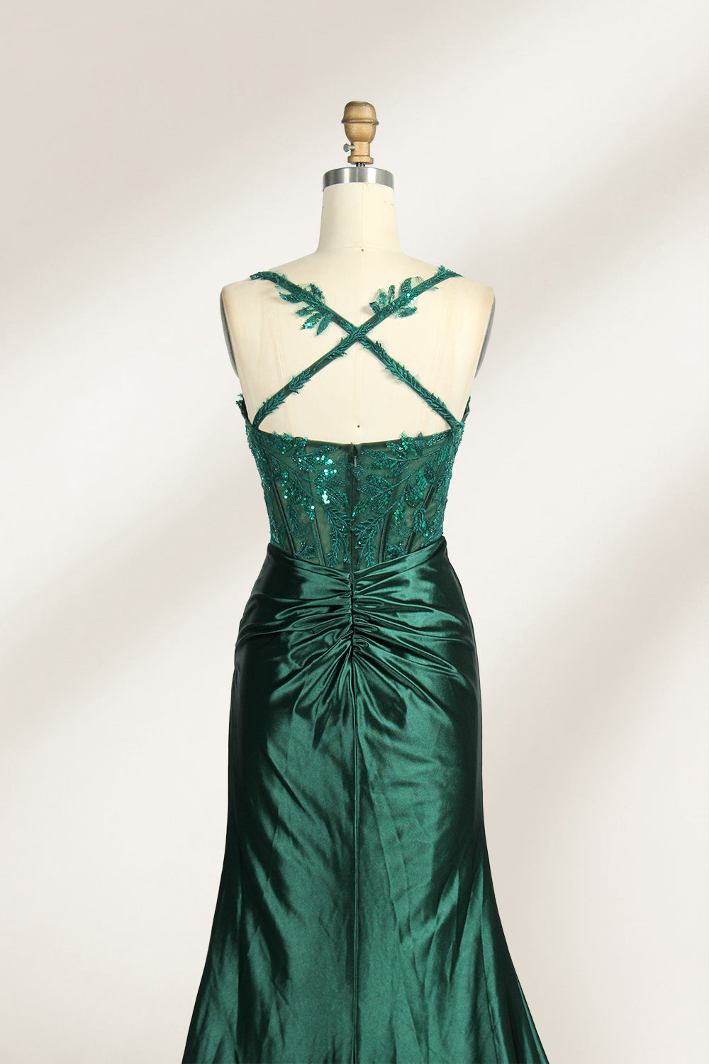 On a mannequin against a light background, there’s a red satin gown. It has thin, delicate straps and a sweetheart neckline. The bodice is adorned with sequin - detailed lace, adding a touch of glamour. The skirt, ruched and mermaid - shaped, features a high side slit and a flowing train. The shiny satin fabric and sequin embellishments make it perfect for formal events like galas.3
