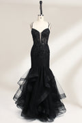 A mannequin displays a black mermaid - style gown. It has thin straps, a deep V - neckline with sheer panels, and intricate black bead embroidery. The layered tulle skirt adds a romantic touch, perfect for formal events like galas or weddings, exuding elegance and sophistication.1
