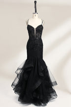 A mannequin displays a black mermaid - style gown. It has thin straps, a deep V - neckline with sheer panels, and intricate black bead embroidery. The layered tulle skirt adds a romantic touch, perfect for formal events like galas or weddings, exuding elegance and sophistication.1
