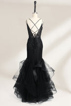 A mannequin displays a black mermaid - style gown. It has thin straps, a deep V - neckline with sheer panels, and intricate black bead embroidery. The layered tulle skirt adds a romantic touch, perfect for formal events like galas or weddings, exuding elegance and sophistication.2