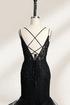 A mannequin displays a black mermaid - style gown. It has thin straps, a deep V - neckline with sheer panels, and intricate black bead embroidery. The layered tulle skirt adds a romantic touch, perfect for formal events like galas or weddings, exuding elegance and sophistication.5