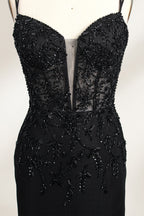 A mannequin displays a black mermaid - style gown. It has thin straps, a deep V - neckline with sheer panels, and intricate black bead embroidery. The layered tulle skirt adds a romantic touch, perfect for formal events like galas or weddings, exuding elegance and sophistication.6