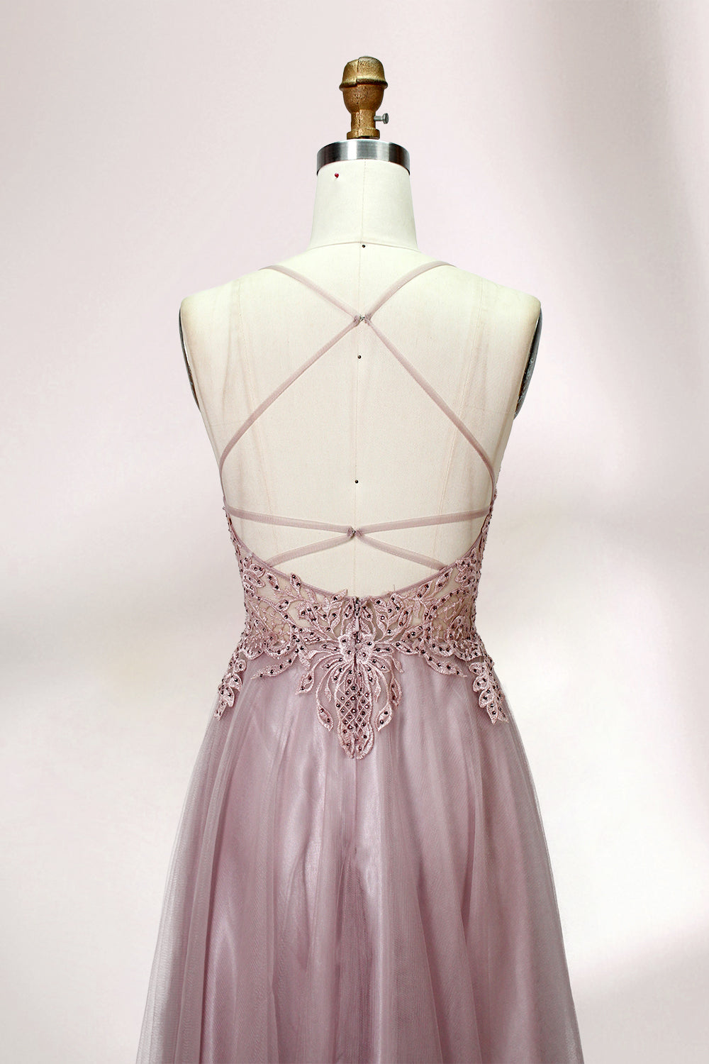 Blush pink tulle prom dress with beaded sheer bodice, V-neck, criss-cross back & flowing skirt. Elegant, dreamy design—perfect for bulk premium partywear stock.06