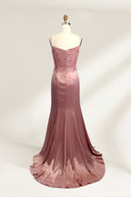 A photograph of a model mannequin wearing a floor-length, mauve satin gown with a deep V-neckline. The bodice is adorned with intricate lace detailing, featuring floral patterns and a subtle sheen. The gown has a thigh-high slit on the right side, adding a touch of elegance. The mannequin stands against a plain white background, highlighting the dress's smooth texture and elegant silhouette.02
