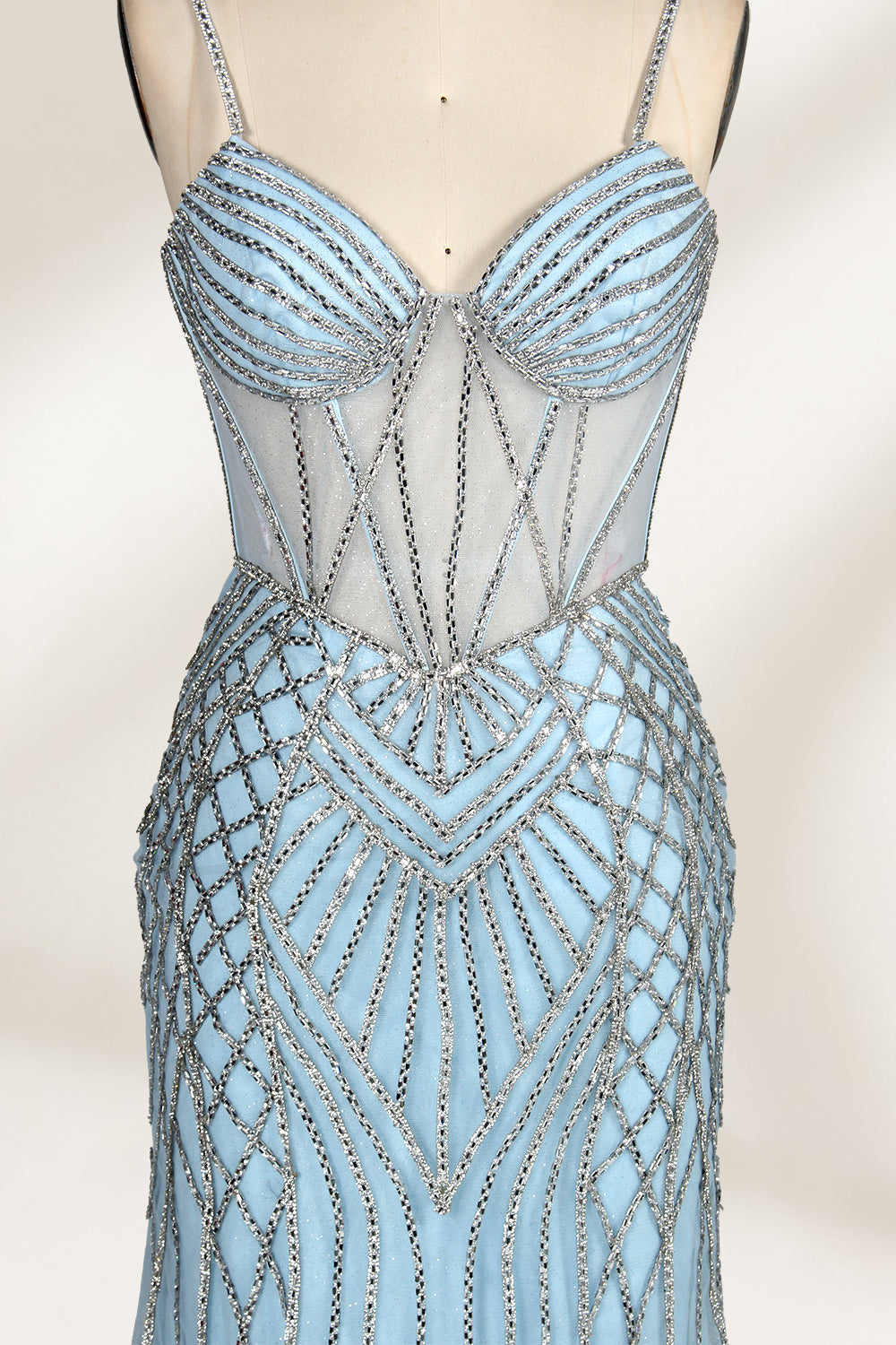 A close - up of a light - blue tulle gown with intricate silver beading. It has a strapless, sweetheart neckline and sheer bodice. The geometric beading pattern adds glamour, perfect for formal events like galas, radiating charm.3