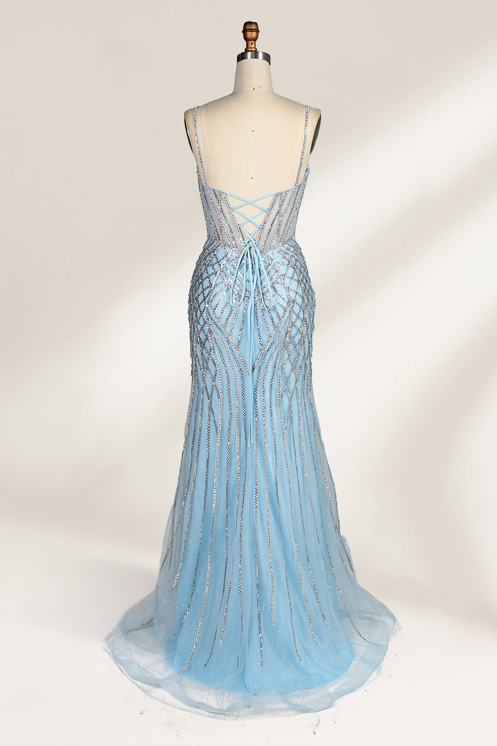 A close - up of a light - blue tulle gown with intricate silver beading. It has a strapless, sweetheart neckline and sheer bodice. The geometric beading pattern adds glamour, perfect for formal events like galas, radiating charm.2