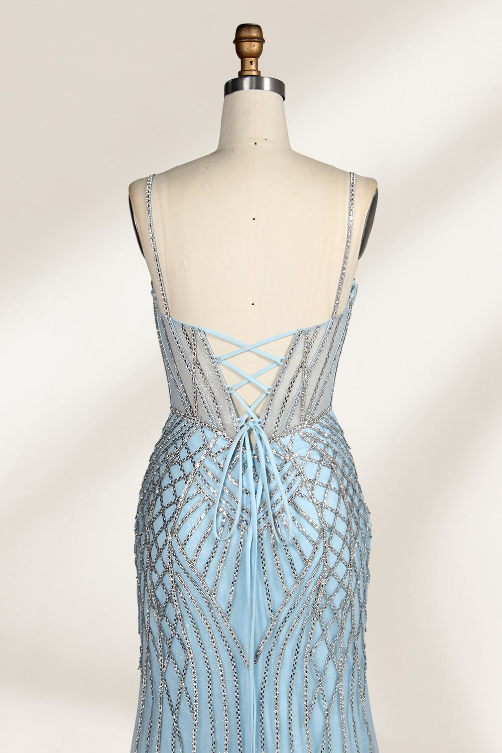 A close - up of a light - blue tulle gown with intricate silver beading. It has a strapless, sweetheart neckline and sheer bodice. The geometric beading pattern adds glamour, perfect for formal events like galas, radiating charm.6
