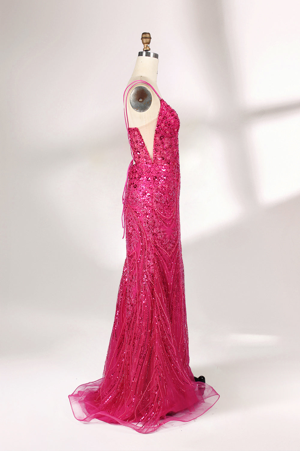 A mannequin showcases a hot - pink, fully beaded gown. It has thin straps, a deep V - neck, and a high side slit. The intricate beadwork adds glamour, making it perfect for formal events like galas or proms, radiating elegance and style.5