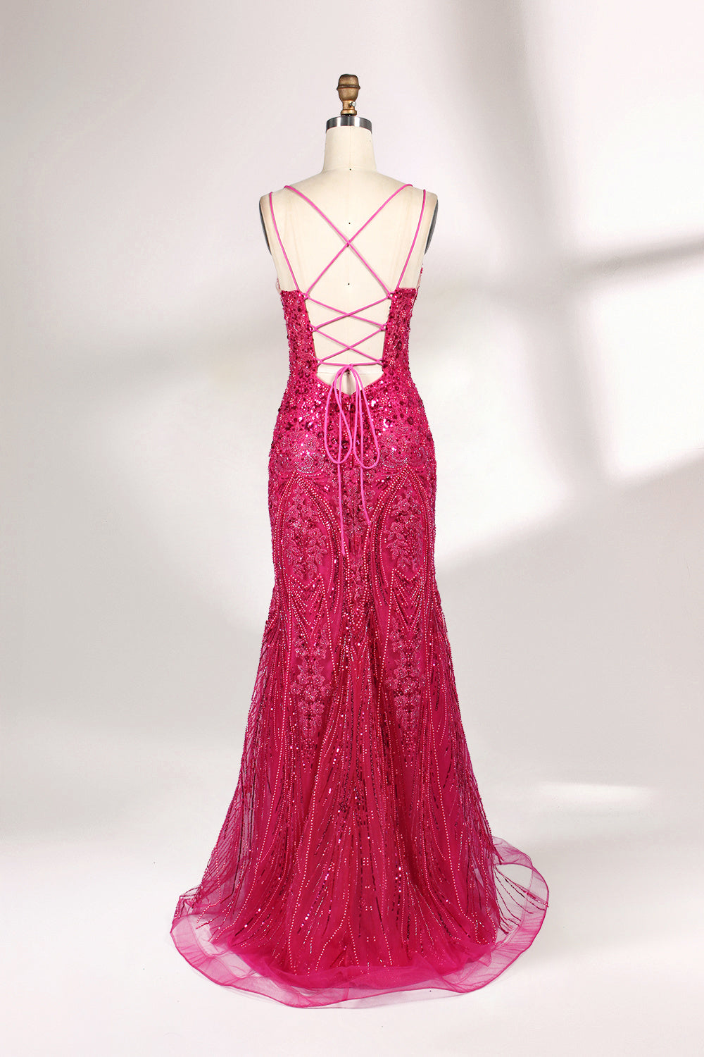 A mannequin showcases a hot - pink, fully beaded gown. It has thin straps, a deep V - neck, and a high side slit. The intricate beadwork adds glamour, making it perfect for formal events like galas or proms, radiating elegance and style.2