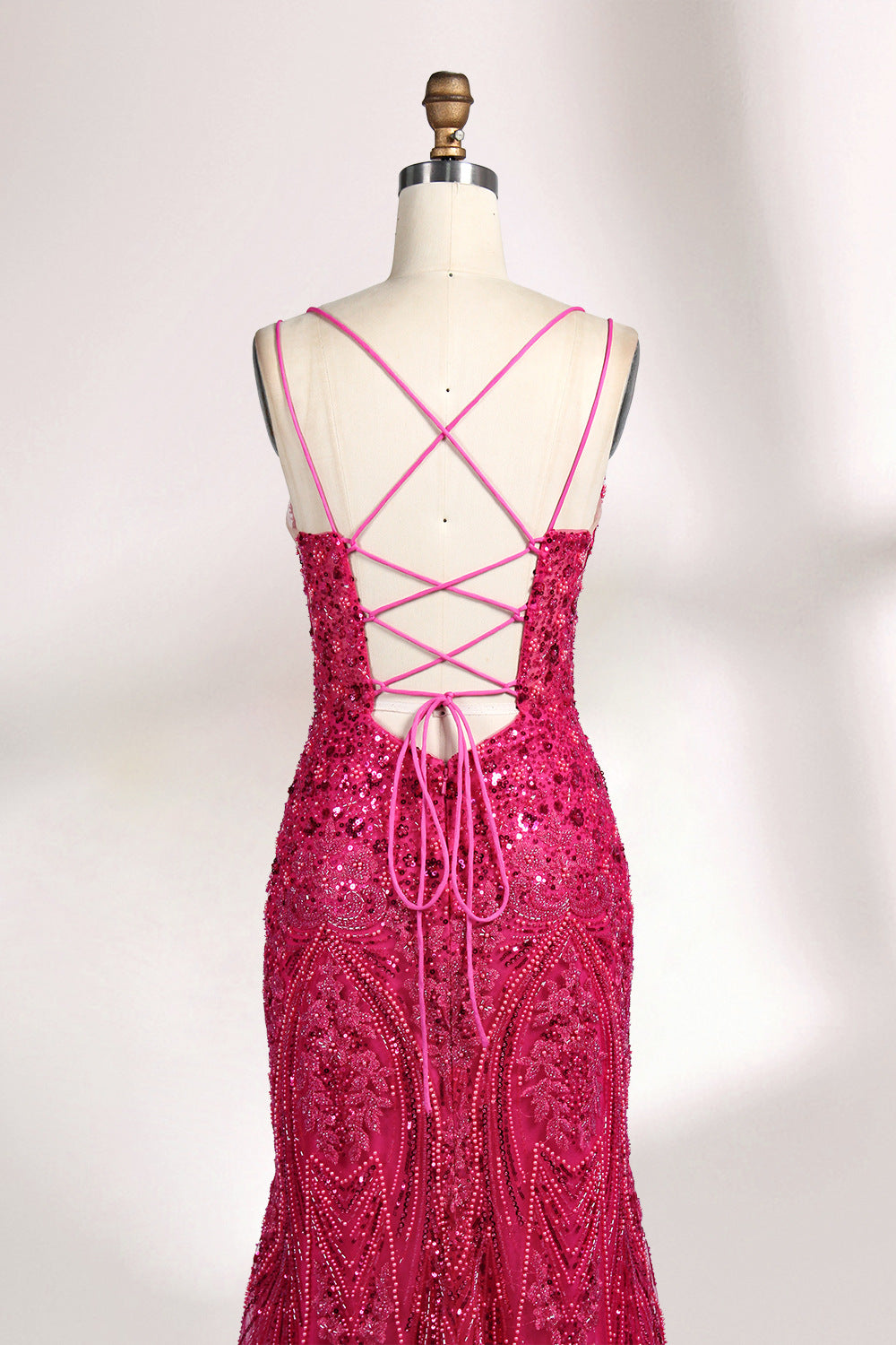 A mannequin showcases a hot - pink, fully beaded gown. It has thin straps, a deep V - neck, and a high side slit. The intricate beadwork adds glamour, making it perfect for formal events like galas or proms, radiating elegance and style.6