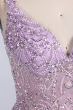 A mannequin showcases a lavender - purple tulle gown. It has a V - neck, beaded bodice, and a voluminous skirt. The elegant design, with intricate beadwork, suits formal events like galas or proms, radiating charm and grace.4