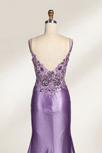 A mannequin showcases a lavender - purple satin gown. It has thin straps, a V - neck, floral - beaded bodice, and a high side slit. The elegant design, blending satin and intricate beadwork, suits formal events like galas or proms, radiating charm.6