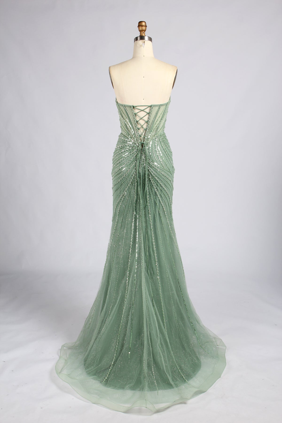 Sage green strapless mermaid prom dress with beaded corset back and crisscross lacing