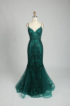A woman stands against a light background, wearing a royal - blue, sequin - adorned mermaid gown. It features thin straps, a deep V - neckline, and a sheer tulle overlay. The sparkling sequins and figure - hugging silhouette create a glamorous look, perfect for formal events like galas or proms, exuding elegance and charm.7