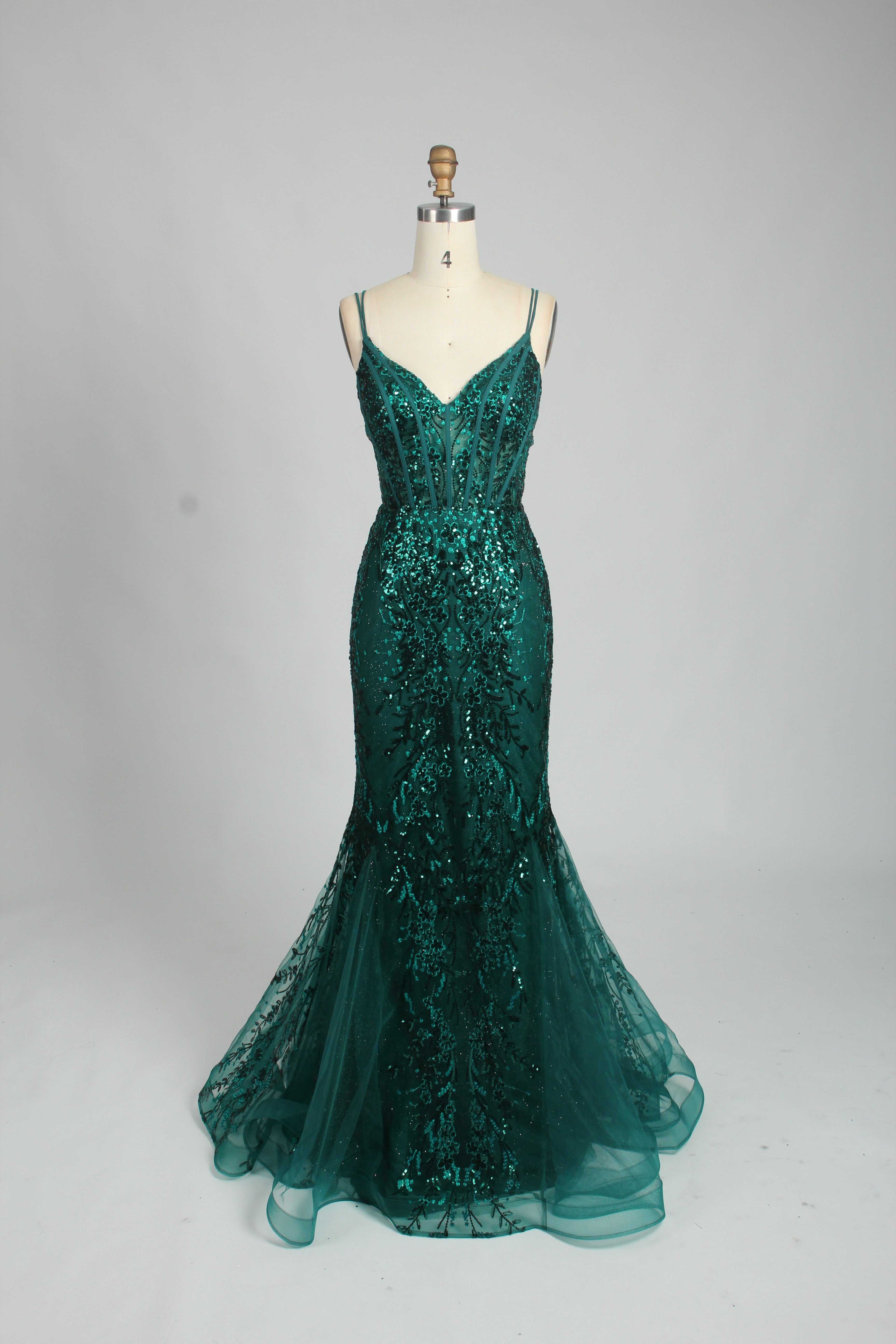 A woman stands against a light background, wearing a royal - blue, sequin - adorned mermaid gown. It features thin straps, a deep V - neckline, and a sheer tulle overlay. The sparkling sequins and figure - hugging silhouette create a glamorous look, perfect for formal events like galas or proms, exuding elegance and charm.7