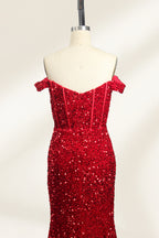 A photograph of a mannequin showcasing an off-the-shoulder, floor-length red sequin gown with a plunging V-neckline. The dress has a fitted bodice and a flared skirt, creating a glamorous, elegant appearance. The mannequin stands against a plain white background, emphasizing the dress's vibrant color and intricate details.06