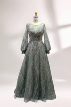 Presented on a mannequin is a deep - red evening gown. It features a sheer neckline, long billowy sleeves, and intricate gold - toned embroidery throughout. The elaborate design gives off a luxurious and elegant vibe, ideal for formal occasions.2
