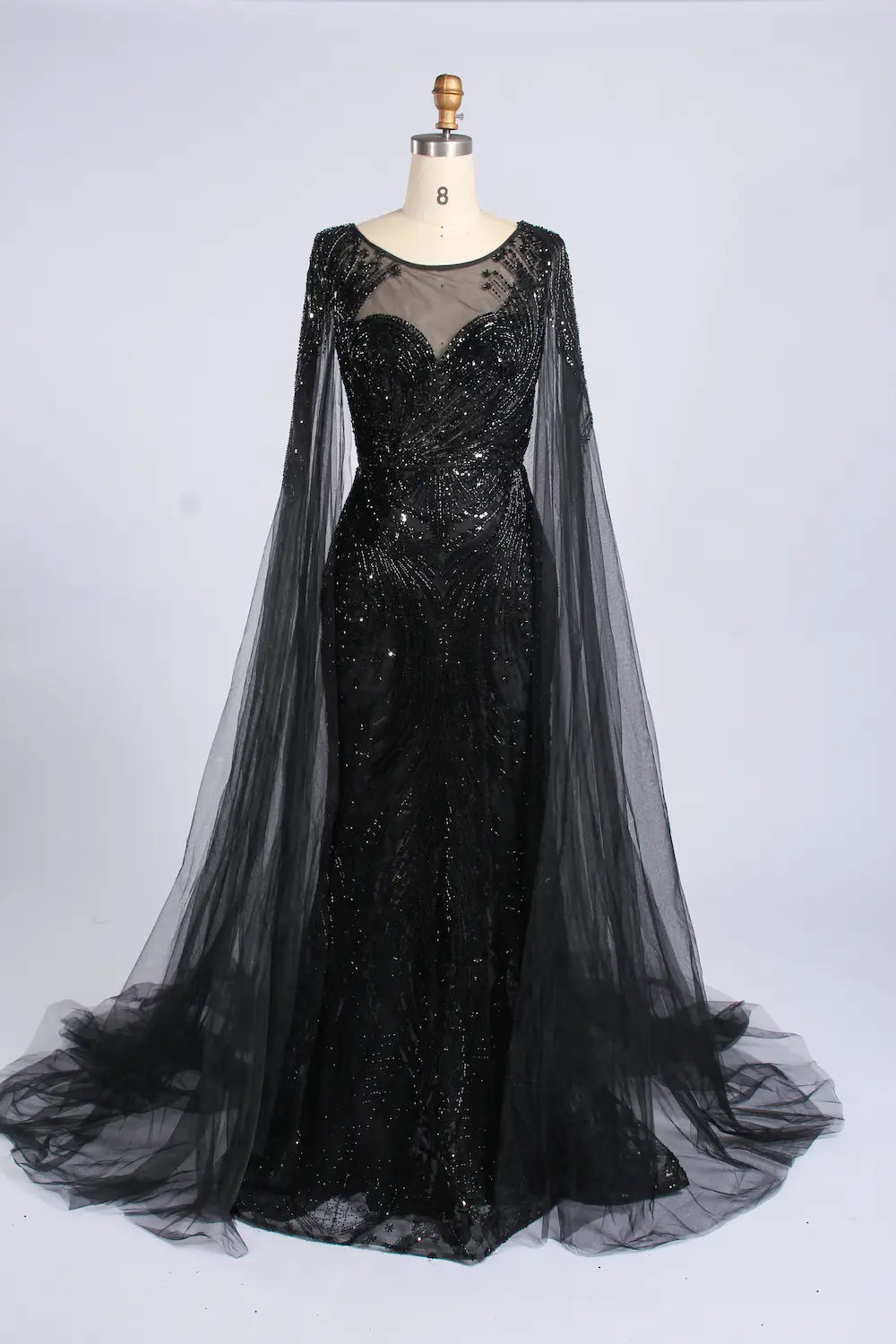 Black beaded cape fit-and-flare gown with long sheer tulle sleeves and full skirt