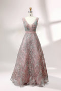 Displayed on a mannequin is a pink - hued evening gown. It features a deep V - neckline, intricate floral embroidery in shades of blue and pink, and a flowing skirt. The elegant design creates a romantic and sophisticated look, perfect for formal events.1