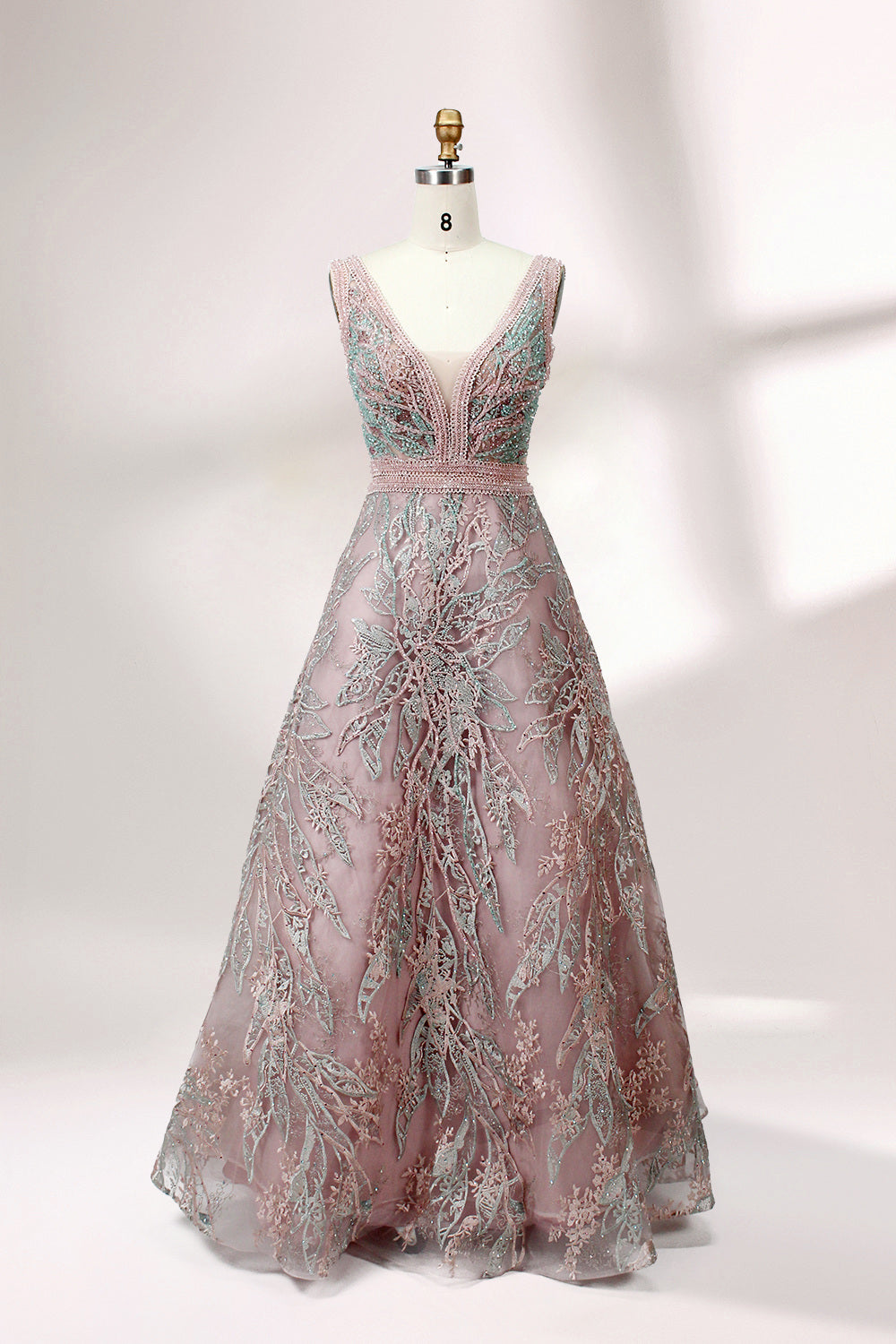 Displayed on a mannequin is a pink - hued evening gown. It features a deep V - neckline, intricate floral embroidery in shades of blue and pink, and a flowing skirt. The elegant design creates a romantic and sophisticated look, perfect for formal events.1