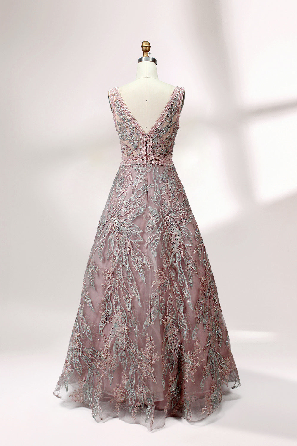 Displayed on a mannequin is a pink - hued evening gown. It features a deep V - neckline, intricate floral embroidery in shades of blue and pink, and a flowing skirt. The elegant design creates a romantic and sophisticated look, perfect for formal events.1
