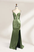 A mannequin showcases an olive - green satin gown. It has thin straps, a deep V - neck, ruched bodice, and a high side slit with sheer details. The elegant design, blending satin and intricate ruching, suits formal events like galas or proms, radiating sophistication.1