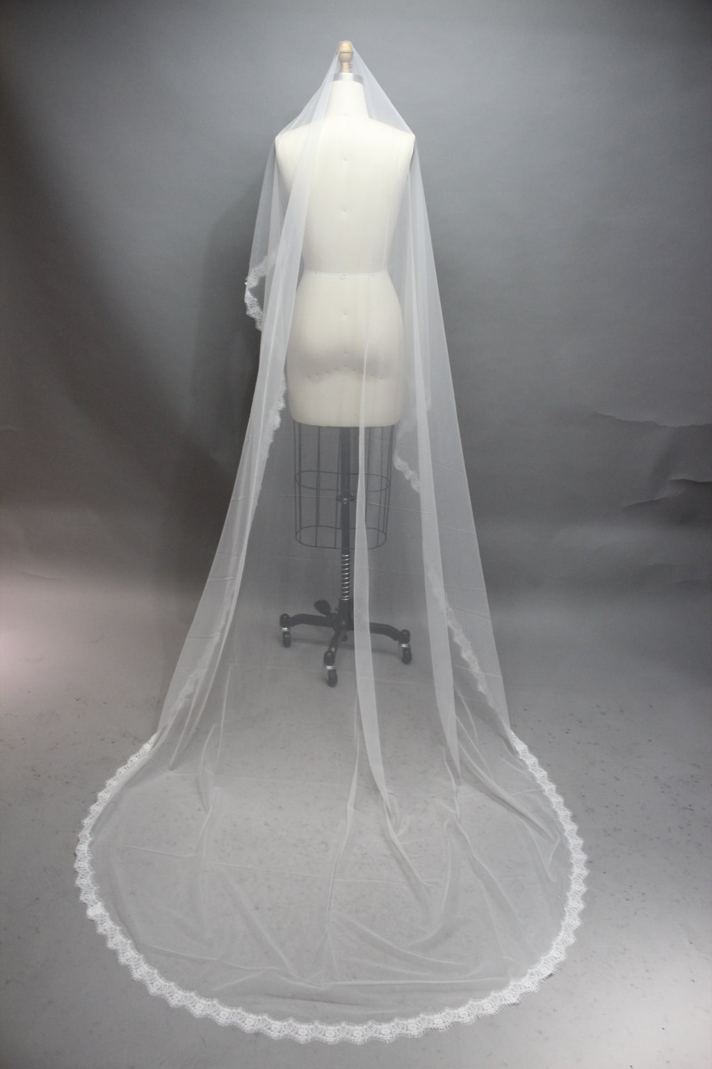 Enhance your bridal accessory offerings with our Wholesale Lace - Edged Long Bridal Veil, Style T267.