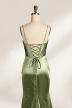 A mannequin showcases an olive - green satin gown. It has thin straps, a deep V - neck, ruched bodice, and a high side slit with sheer details. The elegant design, blending satin and intricate ruching, suits formal events like galas or proms, radiating sophistication.2