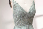 A mannequin showcases a light - green tulle gown with a lace - embroidered, sheer bodice. It has thin straps, a deep V - neckline, and a voluminous skirt. The delicate lace and flowing tulle create a romantic look, perfect for formal events like weddings or proms, exuding elegance.
5