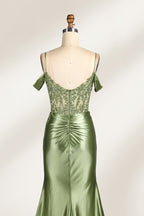A mannequin displays a rose - gold satin gown. It has thin straps, off - shoulder lace - detailed sleeves, a ruched bodice, and a high side slit. The elegant design, blending satin and lace, suits formal events like galas or weddings.6