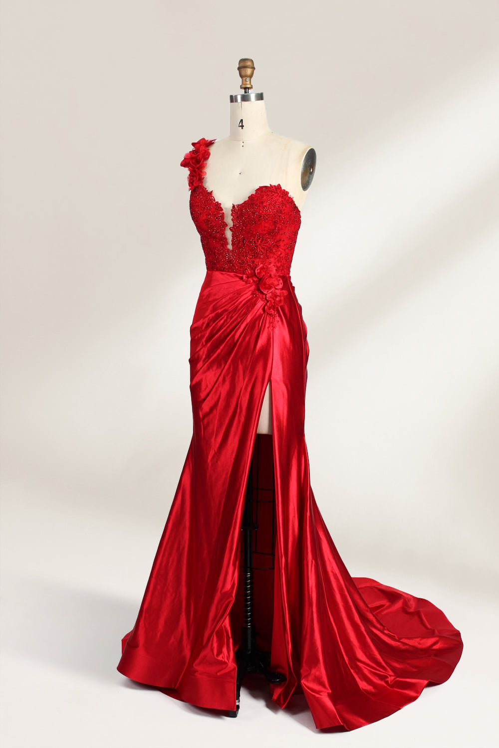 A mannequin displays a teal satin gown. It features a deep V - neckline with lace embroidery on the bodice, a ruched skirt, and a mermaid silhouette. The elegant details and shiny fabric create a glamorous look, perfect for formal events like proms or galas.5