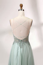 A mannequin showcases a light - green tulle gown with a lace - embroidered, sheer bodice. It has thin straps, a deep V - neckline, and a voluminous skirt. The delicate lace and flowing tulle create a romantic look, perfect for formal events like weddings or proms, exuding elegance.
6