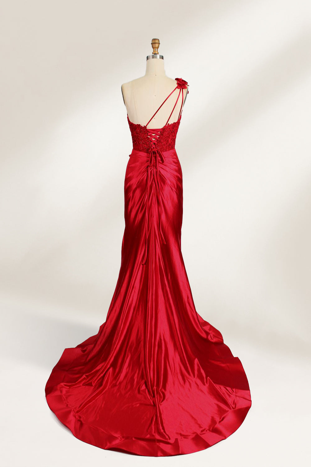 A mannequin displays a teal satin gown. It features a deep V - neckline with lace embroidery on the bodice, a ruched skirt, and a mermaid silhouette. The elegant details and shiny fabric create a glamorous look, perfect for formal events like proms or galas.2