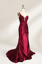 A mannequin displays a teal satin gown. It features a deep V - neckline with lace embroidery on the bodice, a ruched skirt, and a mermaid silhouette. The elegant details and shiny fabric create a glamorous look, perfect for formal events like proms or galas.