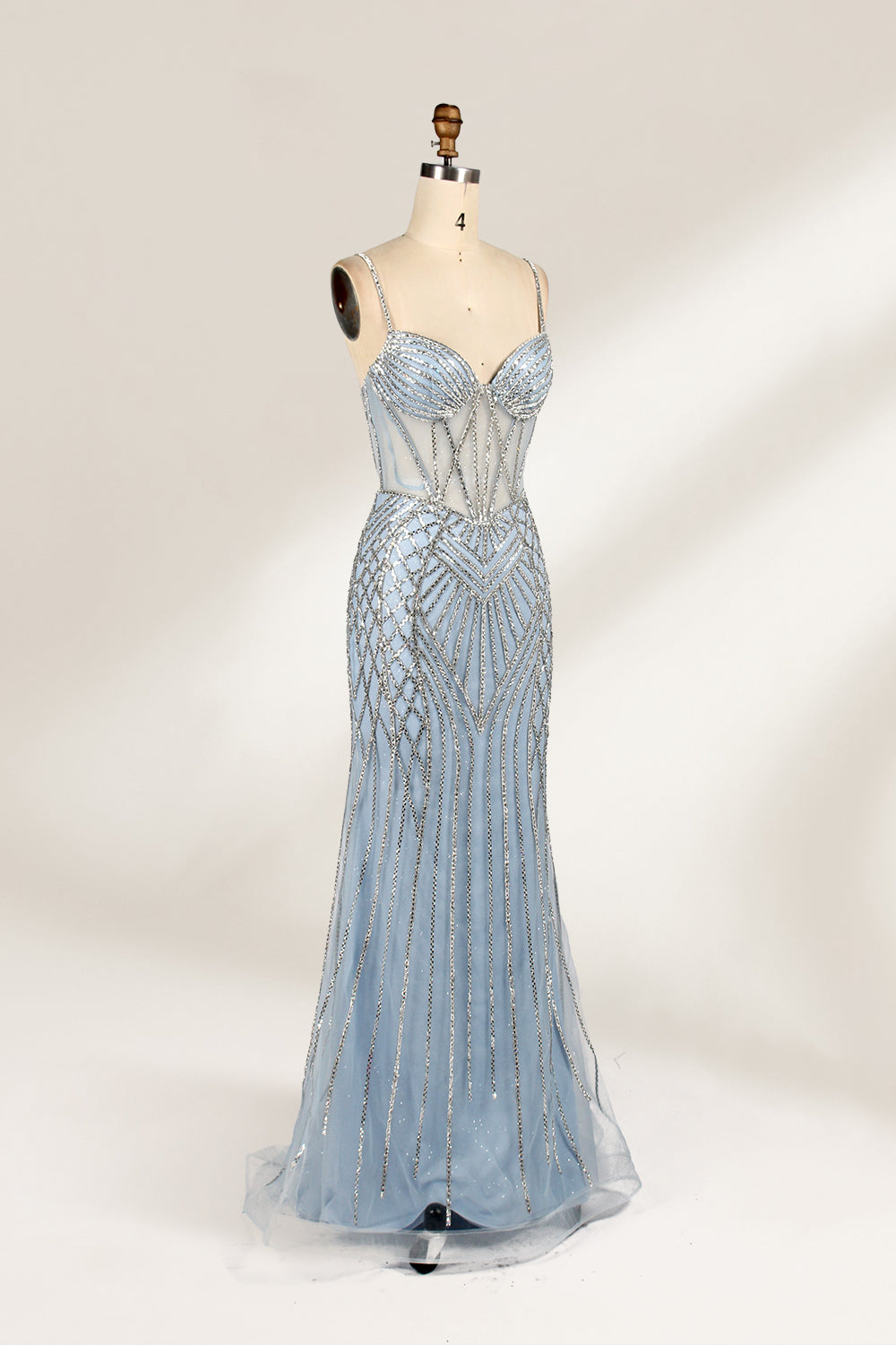 A close - up of a light - blue tulle gown with intricate silver beading. It has a strapless, sweetheart neckline and sheer bodice. The geometric beading pattern adds glamour, perfect for formal events like galas, radiating charm.5